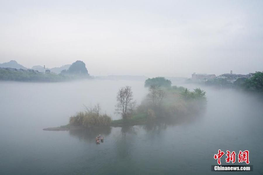 Downtown Guilin City covered in mist in Guangxi Zhuang Autonomous Region, March 28, 2019. Like a green ribbon flowing through the mountains, the Lijiang River is known for its amazing natural beauty. (Photo: China News Service/Tang Mengxian)