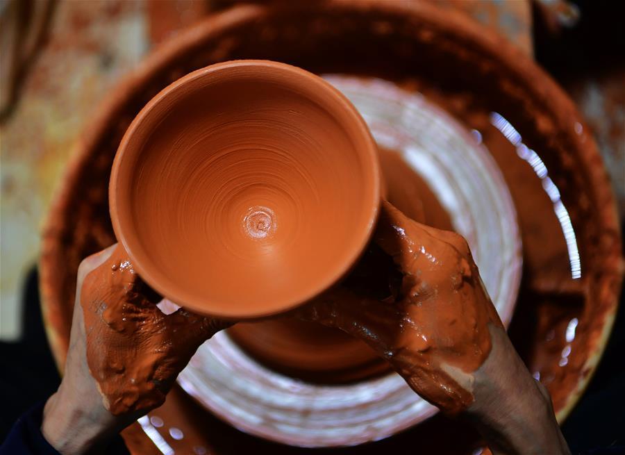 Wu Lizhu, inheritor of the workmanship of Jianzhan teaware, makes a piece of porcelain at his workshop in Jianyang District of Nanping City, south China\'s Fujian Province, March 28, 2019. Jianzhan teaware, a well-known Chinese porcelain originated in Jianyang, dates back to more than 1,000 years ago in Song dynasty (960-1279). It was the best teaware for scholars and literati to use during that time in tea competitions. Jianzhan teawares are known for their variability. Glazes can range in color from dark plum to yellow, green, and blue. During the heating and cooling processes, iron element in the clay can migrate within the glaze to form surface crystals in rich and glossy colors, as in the \
