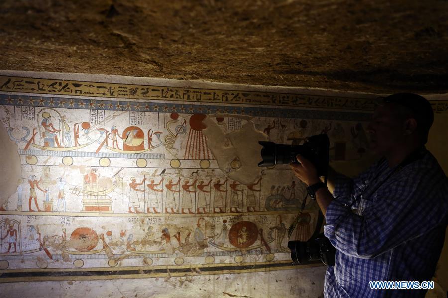 A man takes photos at the site of a tomb in Sohag, Egypt, April 5, 2019. The Egyptian Minister of Antiquities announced on Friday the discovery of a tomb, dating back to the Ptolemaic era which spans from 305 BC to 30 BC, in Sohag province south of the capital Cairo. (Xinhua/Ahmed Gomaa)