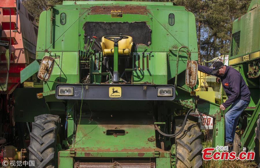 Richard Manners, parts specialist looks over some of the combines. 350 dead combines sit in a field, are broken for parts and exported around the world in a container, where they are welded back together on arrival. April 6 2019.  (Photo/VCG)