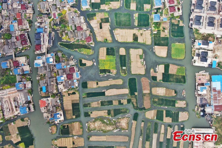 An aerial view of colorful fields crisscrossed by water in a rural area in Xinghua City, East China\'s Jiangsu Province, April 10, 2019. Locals have a tradition of digging mud from trenches or small rivers to form small plots of land. (Photo: China News Service/Yang Bo)
