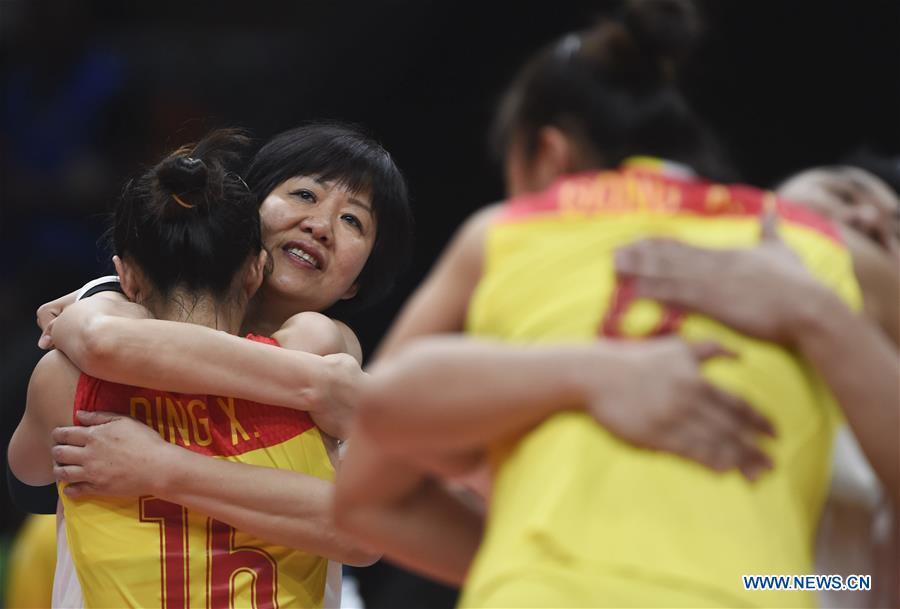 File photo taken on August 20, 2016 shows that Lang Ping (2nd L), head coach of China\'s team, hugs teammate Ding Xia during the women\'s gold medal match of Volleyball at the 2016 Rio Olympic Games in Rio de Janeiro, Brazil. From sending athletes to Helsinki Summer Olympic Games for the very first time in 1952 to winning the bid to host 2022 Winter Olympic Games in 2015, the People\'s Republic of China went through a remarkable history of sports, including successfully hosting the 2008 Summer Olympic Games and preparing for the upcoming 2022 Winter Olympic Games. (Xinhua/Li Ga)