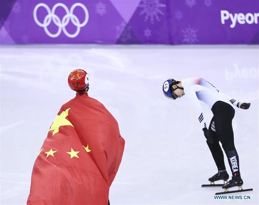 File photo taken on Feb. 22, 2018 shows China\'s Wu Dajing (L) celebrating victory after men\'s 500m final of short track speed skating at the 2018 PyeongChang Winter Olympic Games at Gangneung Ice Arena, Gangneung, South Korea. Wu Dajing is China\'s first male Winter Olympic gold medalist. From sending athletes to Helsinki Summer Olympic Games for the very first time in 1952 to winning the bid to host 2022 Winter Olympic Games in 2015, the People\'s Republic of China went through a remarkable history of sports, including successfully hosting the 2008 Summer Olympic Games and preparing for the upcoming 2022 Winter Olympic Games. (Xinhua/Lan Hongguang)