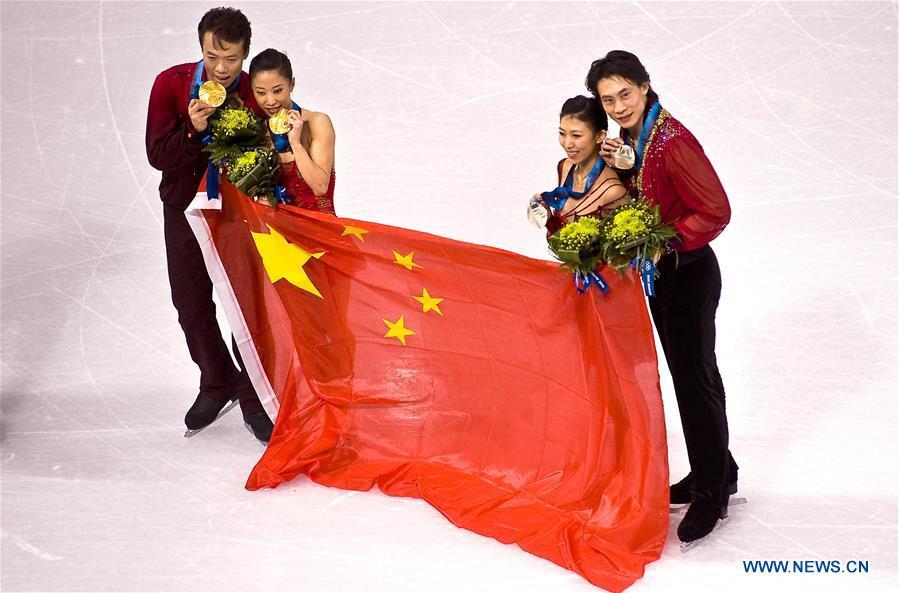 File photo taken on Feb. 15, 2010 shows gold medalists Shen Xue (2nd L) and Zhao Hongbo (1st L) of China, compatriots and silver medalists Pang Qing (2nd R) and Tong Jian pose with the Chinese national flag during the medals ceremony for the figure skating pairs event at the 2010 Winter Olympics at the Pacific Coliseum in Vancouver, Canada. Shen Xue/Zhao Hongbo won the China\'s first Olympic gold medal in figure skating. From sending athletes to Helsinki Summer Olympic Games for the very first time in 1952 to winning the bid to host 2022 Winter Olympic Games in 2015, the People\'s Republic of China went through a remarkable history of sports, including successfully hosting the 2008 Summer Olympic Games and preparing for the upcoming 2022 Winter Olympic Games. (Xinhua/Chen Xiaowei)