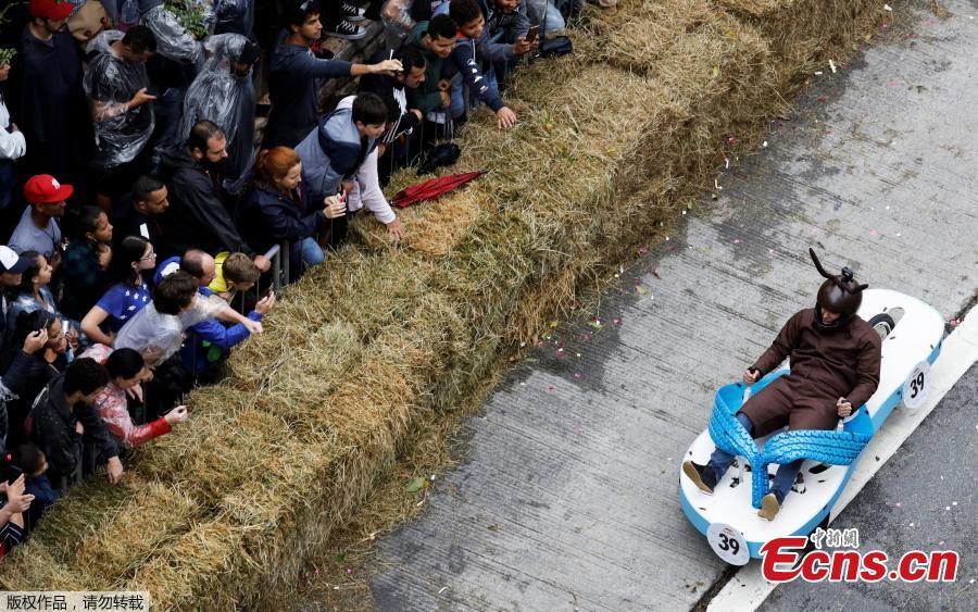 Competitors ride a homemade vehicle on a downhill track during the Red Bull Soapbox Race in Sao Paulo, Brazil, April 14, 2019. The Red Bull Soapbox race is an annual event where amateur drivers race their homemade soapbox vehicles down a hill through obstacles. (Photo/Agencies)