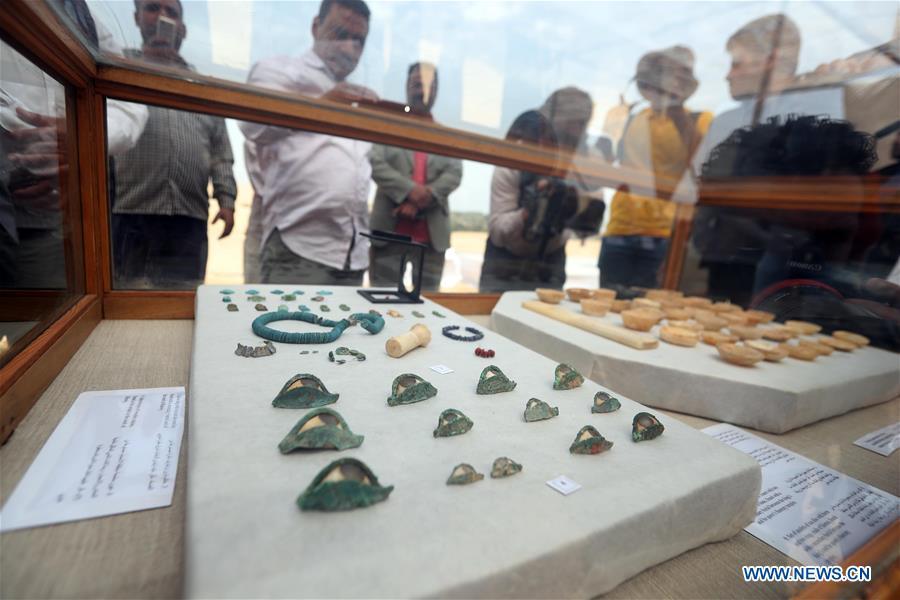 People look at the unearthed artifacts in a tomb in Saqqara, Egypt on April 13, 2019. Egyptian Ministry of Antiquities opened on Saturday a tomb of a Fifth Dynasty dignitary which was discovered recently at Saqqara Necropolis near the Giza pyramids. Minister of Antiquities Khaled al-Anany, along with 52 ambassadors and cultural attaches of foreign, Arab and African countries, toured Saqqara Necropolis to inspect the tomb of Khuwy, who lived at the end of the Fifth Dynasty of the Old Kingdom. The Old Kingdom of Egypt is the period spanning 2686 BC to 2181 BC, which is also known as the Age of the Pyramids. (Xinhua/Ahmed Gomaa)