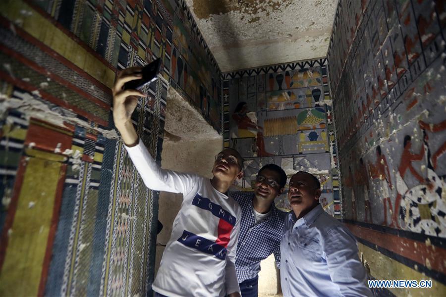 People take selfies in a tomb in Saqqara, Egypt on April 13, 2019. Egyptian Ministry of Antiquities opened on Saturday a tomb of a Fifth Dynasty dignitary which was discovered recently at Saqqara Necropolis near the Giza pyramids. Minister of Antiquities Khaled al-Anany, along with 52 ambassadors and cultural attaches of foreign, Arab and African countries, toured Saqqara Necropolis to inspect the tomb of Khuwy, who lived at the end of the Fifth Dynasty of the Old Kingdom. The Old Kingdom of Egypt is the period spanning 2686 BC to 2181 BC, which is also known as the Age of the Pyramids. (Xinhua/Ahmed Gomaa)
