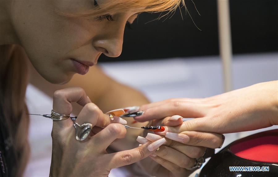 A competitor works on nail painting during the Nail Art Challenge at the 2019 Revel in Beauty event in Toronto, Canada, on April 15, 2019. The Nail Art Challenge was held on Monday to showcase the creative process of nail art to spectators. (Xinhua/Zou Zheng)