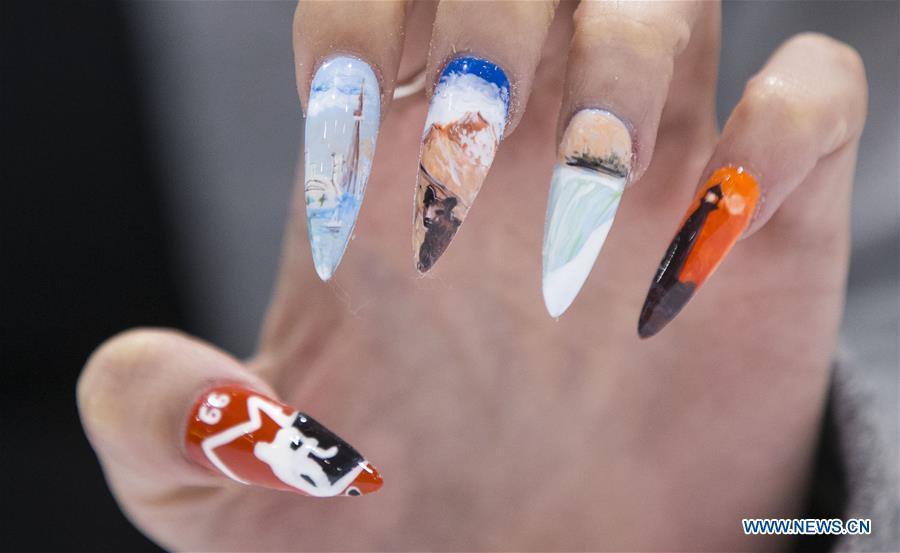 A model displays her nail fashion during the Nail Art Challenge at the 2019 Revel in Beauty event in Toronto, Canada, on April 15, 2019. The Nail Art Challenge was held on Monday to showcase the creative process of nail art to spectators. (Xinhua/Zou Zheng)