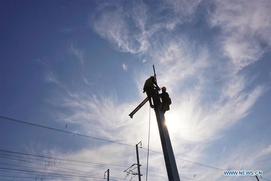 Builders of China Railway 12th Bureau Group work on the Liying section of the Beijing-Xiongan intercity railway, April 15, 2019. Track-laying work of the Beijing-Xiongan intercity railway began on Monday. (Xinhua/Xing Guangli)