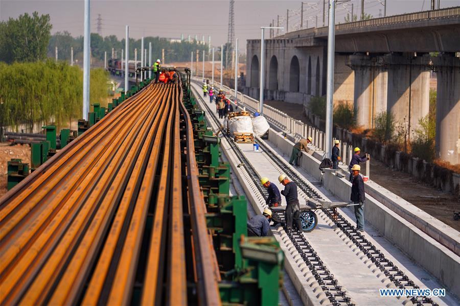 Builders of China Railway 12th Bureau Group work on the Liying section of the Beijing-Xiongan intercity railway, April 15, 2019. Track-laying work of the Beijing-Xiongan intercity railway began on Monday. (Xinhua/Xing Guangli)