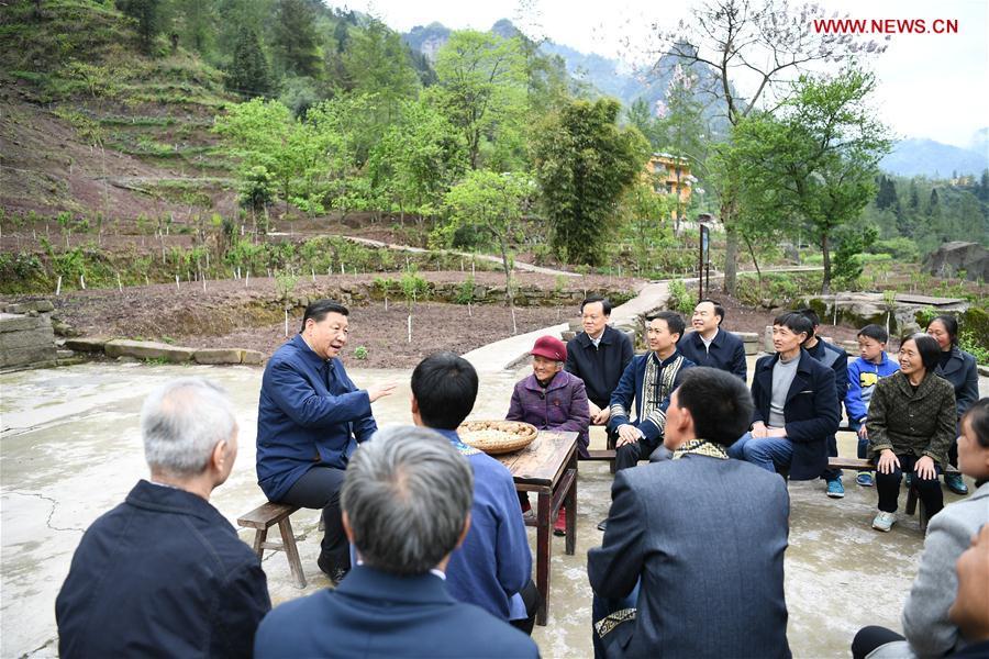 Chinese President Xi Jinping, also general secretary of the Communist Party of China Central Committee and chairman of the Central Military Commission, talks with villagers to learn about the progress of poverty alleviation and in solving prominent problems including meeting the basic need of food and clothing and guaranteeing compulsory education, basic medical care and safe housing, in Huaxi Village of Shizhu Tujia Autonomous County, southwest China\'s Chongqing, April 15, 2019. Xi went on an inspection tour in southwest China\'s Chongqing Municipality Monday. (Xinhua/Xie Huanchi)