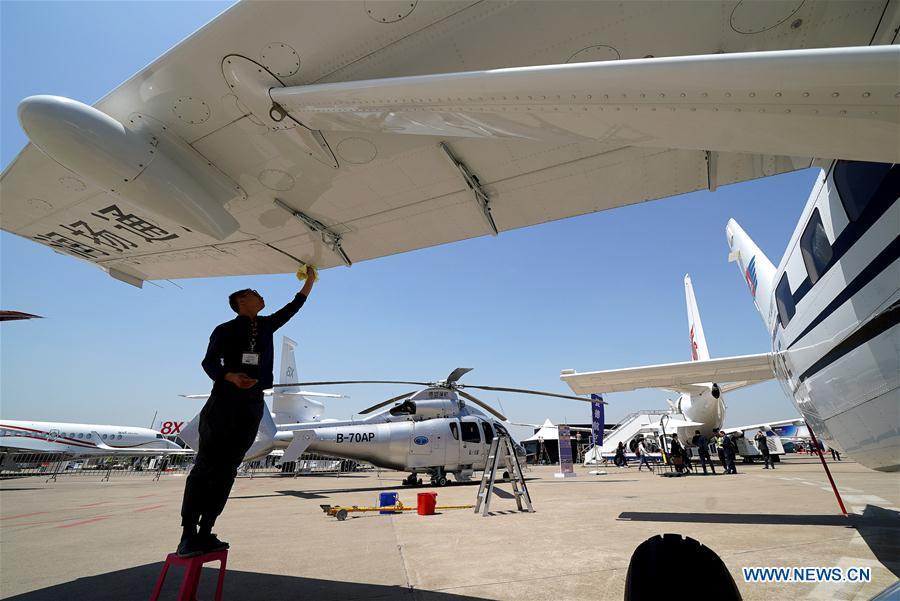 A staff member cleans an aircraft to prepare it for the upcoming 2019 Asian Business Aviation Conference & Exhibition at Shanghai Hongqiao International Airport in east China\'s Shanghai, April 15, 2019. The 2019 Asian Business Aviation Conference & Exhibition (ABACE) will be held from April 16 to 18 at a business aviation service center of Shanghai Hongqiao International Airport. The event is participated by about 150 global exhibitors showcasing more than 30 aircrafts. (Xinhua/Chen Fei)