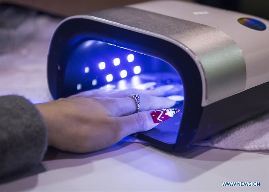 A model dries her nails during the Nail Art Challenge at the 2019 Revel in Beauty event in Toronto, Canada, on April 15, 2019. The Nail Art Challenge was held on Monday to showcase the creative process of nail art to spectators. (Xinhua/Zou Zheng)