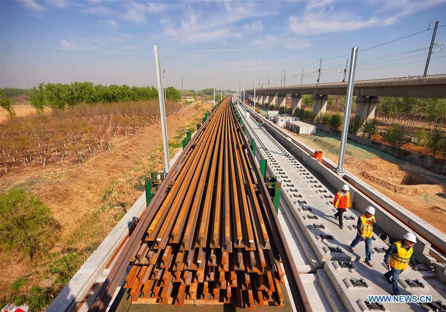 Builders of China Railway 12th Bureau Group work on the Liying section of the Beijing-Xiongan intercity railway, April 15, 2019. Track-laying work of the Beijing-Xiongan intercity railway began on Monday. (Xinhua/Xing Guangli)