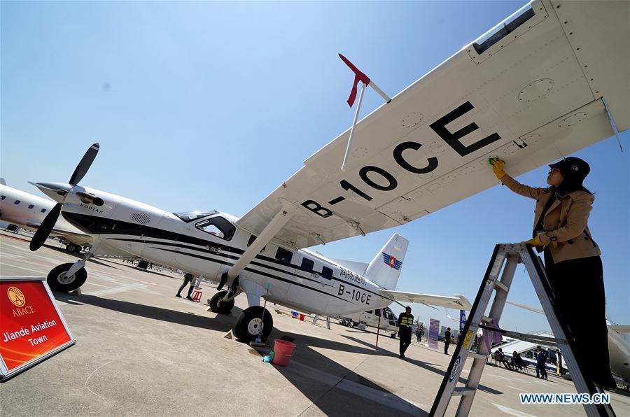 A staff member cleans an aircraft to prepare it for the upcoming 2019 Asian Business Aviation Conference & Exhibition at Shanghai Hongqiao International Airport in east China\'s Shanghai, April 15, 2019. The 2019 Asian Business Aviation Conference & Exhibition (ABACE) will be held from April 16 to 18 at a business aviation service center of Shanghai Hongqiao International Airport. The event is participated by about 150 global exhibitors showcasing more than 30 aircrafts. (Xinhua/Chen Fei)