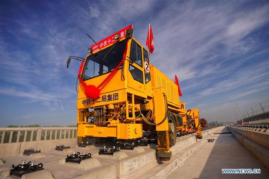 Builders of China Railway 12th Bureau Group operate machine to lay tracks at the construction site of the Liying section of the Beijing-Xiongan intercity railway, April 15, 2019. Track-laying work of the Beijing-Xiongan intercity railway began on Monday. (Xinhua/Xing Guangli)