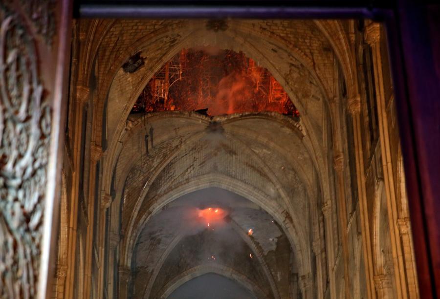 Photo shows the burning roof of Notre-Dame inside the cathedral.  A blaze broke out on Monday afternoon at the Notre Dame Cathedral in central Paris. (Photo/Agencies)