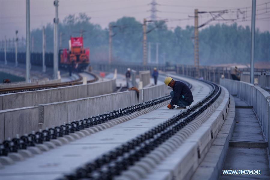 Builders of China Railway 12th Bureau Group work on the Liying section of the Beijing-Xiongan intercity railway, April 15, 2019. Track-laying work of the Beijing-Xiongan intercity railway began on Monday. (Xinhua/Xing Guangli)