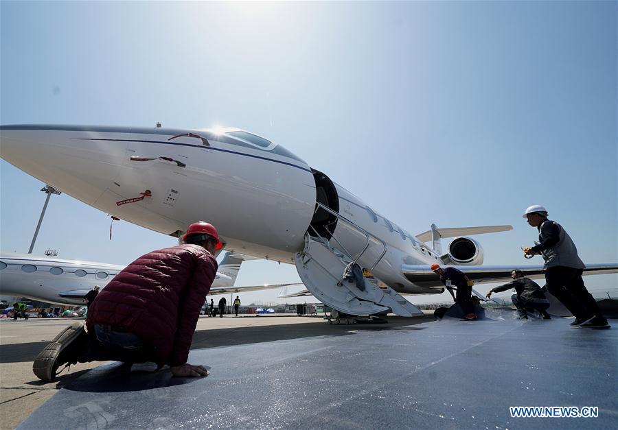 Staff members work to prepare for the upcoming 2019 Asian Business Aviation Conference & Exhibition at Shanghai Hongqiao International Airport in east China\'s Shanghai, April 15, 2019. The 2019 Asian Business Aviation Conference & Exhibition (ABACE) will be held from April 16 to 18 at a business aviation service center of Shanghai Hongqiao International Airport. The event is participated by about 150 global exhibitors showcasing more than 30 aircrafts. (Xinhua/Chen Fei)