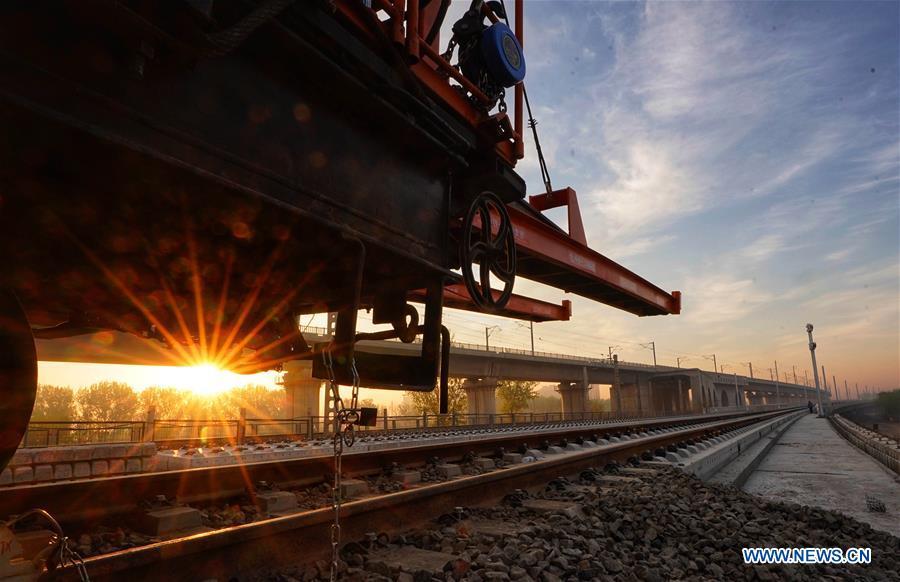 Builders of China Railway 12th Bureau Group operate machine to lay tracks at the construction site of the Liying section of the Beijing-Xiongan intercity railway, April 15, 2019. Track-laying work of the Beijing-Xiongan intercity railway began on Monday. (Xinhua/Xing Guangli)