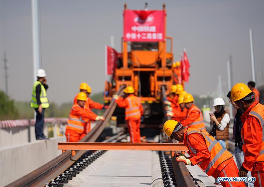 Builders of China Railway 12th Bureau Group work on the Liying section of the Beijing-Xiongan intercity railway, April 15, 2019. Track-laying work of the Beijing-Xiongan intercity railway began on Monday. (Xinhua/Xing Guangli)