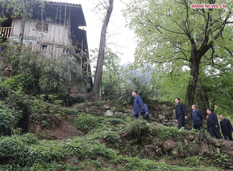 Chinese President Xi Jinping, also general secretary of the Communist Party of China Central Committee and chairman of the Central Military Commission, walks to a villager\'s home to learn about the progress of poverty alleviation and in solving prominent problems including meeting the basic need of food and clothing and guaranteeing compulsory education, basic medical care and safe housing, in Huaxi Village of Shizhu Tujia Autonomous County, southwest China\'s Chongqing, April 15, 2019. Xi went on an inspection tour in southwest China\'s Chongqing Municipality Monday. (Xinhua/Wang Ye)