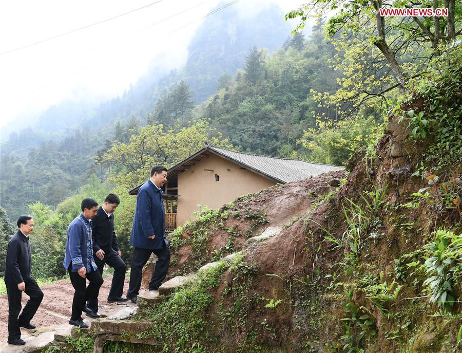 Chinese President Xi Jinping, also general secretary of the Communist Party of China Central Committee and chairman of the Central Military Commission, walks to a villager\'s home to learn about the progress of poverty alleviation and in solving prominent problems including meeting the basic need of food and clothing and guaranteeing compulsory education, basic medical care and safe housing, in Huaxi Village of Shizhu Tujia Autonomous County, southwest China\'s Chongqing, April 15, 2019. Xi went on an inspection tour in southwest China\'s Chongqing Municipality Monday. (Xinhua/Xie Huanchi)