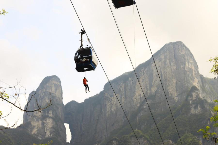 A rescue worker travels along the ropeway to a \