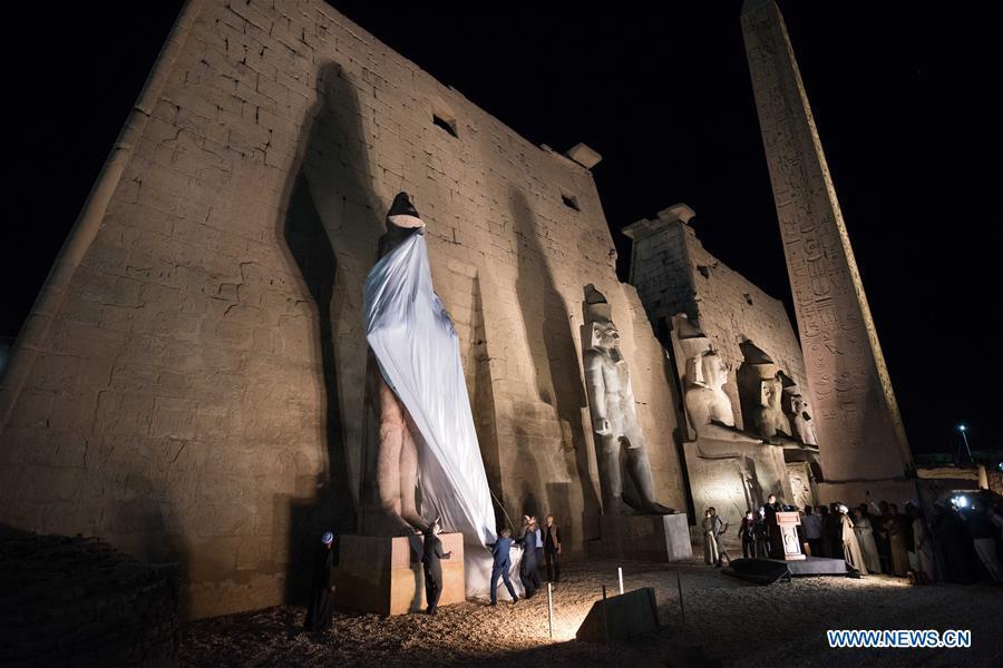 People attend the unveiling of a colossus of ancient Egyptian King Ramses II at Luxor Temple in Luxor, Egypt, April 18, 2019. Egypt\'s Ministry of Antiquities unveiled on Thursday evening a 60-ton statue of ancient Egyptian King Ramses II at the Luxor Temple after its restoration and re-erection on the Nile River\'s east bank in the southern province of Luxor. (Xinhua/Meng Tao)