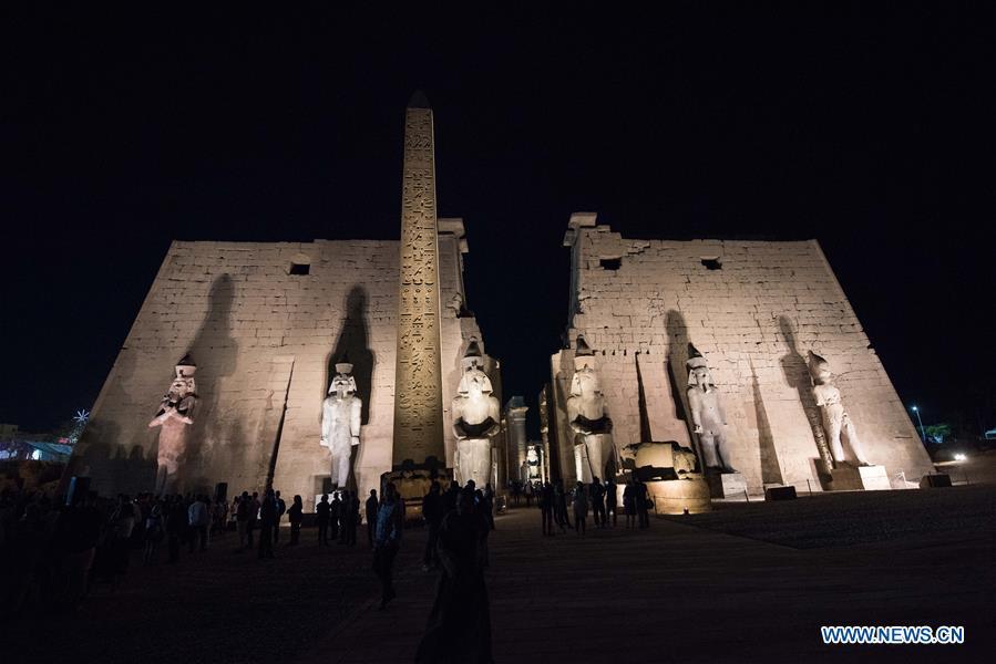 People attend the unveiling of a colossus of ancient Egyptian King Ramses II at Luxor Temple in Luxor, Egypt, April 18, 2019. Egypt\'s Ministry of Antiquities unveiled on Thursday evening a 60-ton statue of ancient Egyptian King Ramses II at the Luxor Temple after its restoration and re-erection on the Nile River\'s east bank in the southern province of Luxor. (Xinhua/Meng Tao)
