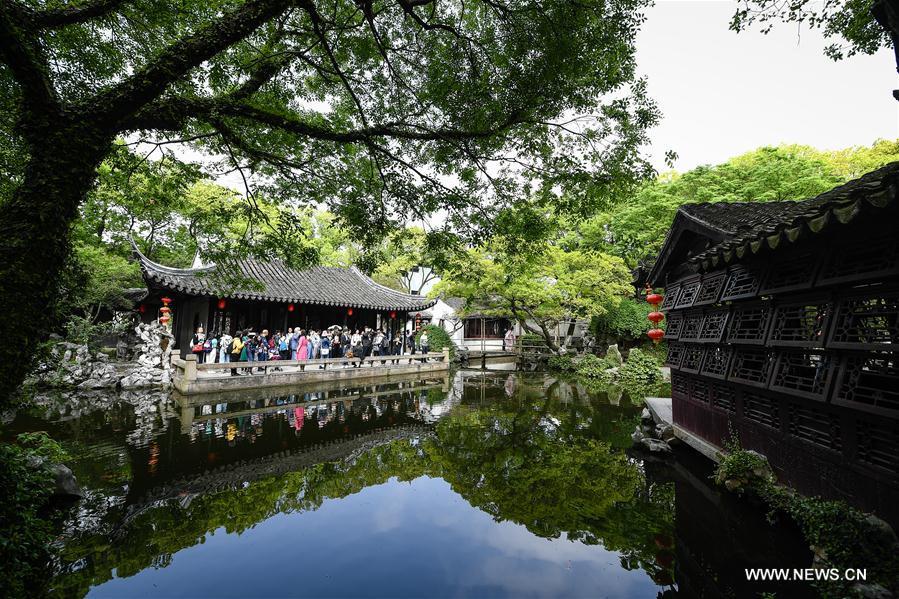 People visit the Retreat &Reflection Garden in Suzhou, east China\'s Jiangsu Province, April 19, 2019. Suzhou is home to dozens of famous classical gardens that have inventive and exquisite design and oriental aesthetics. Nowadays more than 60 of them are still in existence, among which the Humble Administrator\'s Garden, Lingering Garden and the Lion Grove Garden are on the UNESCO\'s World Heritage List. (Xinhua/Li Xiang)
