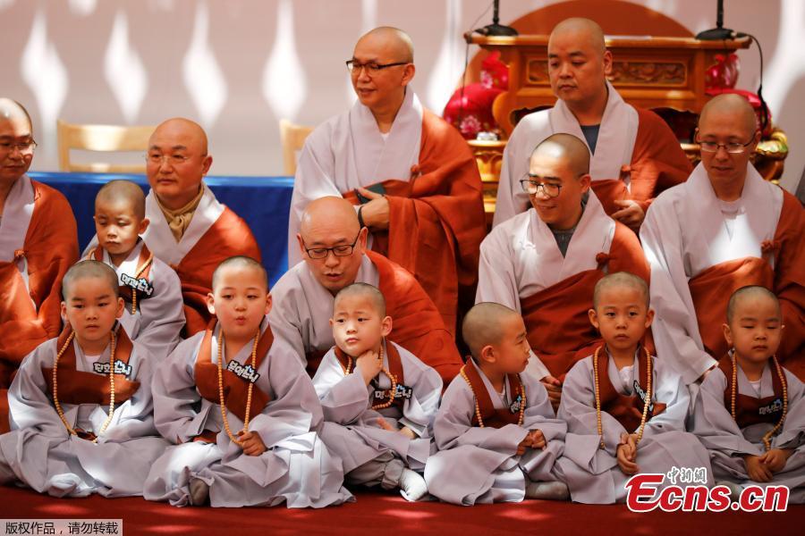 Young novice monks gather after having their heads shaved during the \'Children becoming Buddhist monks\' ceremony at the Jogyesa temple in Seoul, South Korea, April 22, 2019. The children will stay at the temple to learn about Buddhism for 21 days. South Korean Buddhists prepare to celebrate Buddha\'s upcoming birthday on May 12, 2019. (Photo/Agencies)