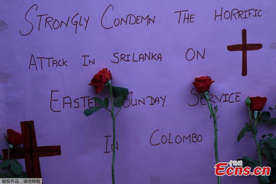 A sign and roses placed for the victims of Sri Lanka\'s serial bomb blasts, are displayed outside a church in Peshawar, Pakistan April 21, 2019.  (Photo/Agencies)