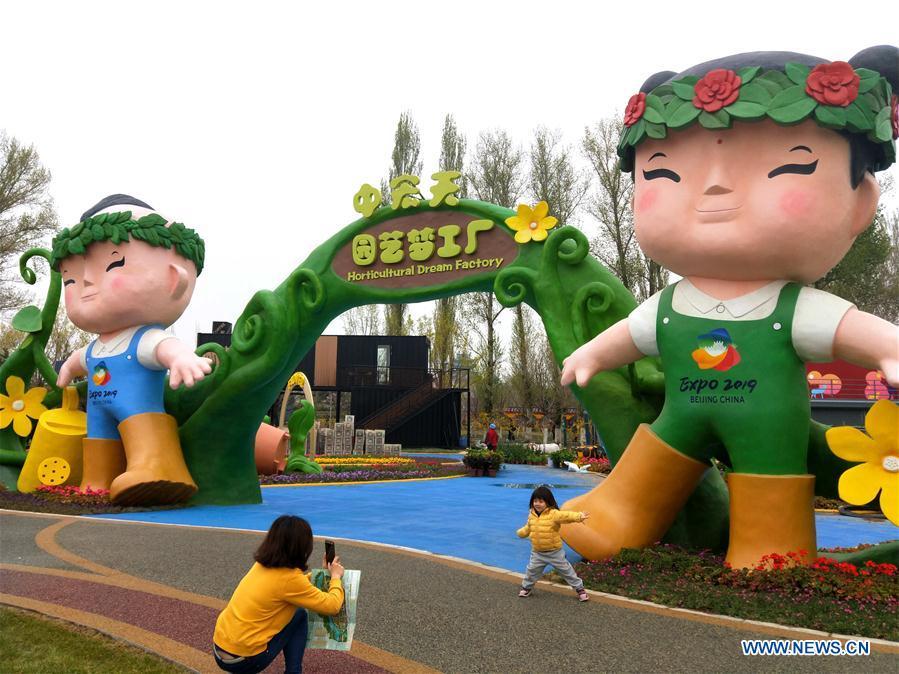 Photo taken with a mobile phone shows people visiting the 2019 Beijing International Horticultural Exhibition (Expo 2019 Beijing) venue during a trial run in Yanqing District of Beijing, capital of China, April 20, 2019. Beijing on Saturday held a trial opening of the site for the upcoming 2019 Beijing International Horticultural Exhibition to test the reception capacity of the event. About 60,000 people visited the 503-hectare expo site Saturday. (Xinhua/Wei Mengjia)