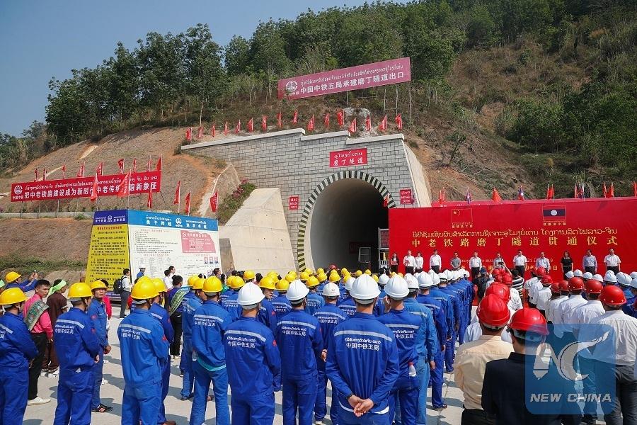 A photo taken on March 21, 2019 shows the drilling-through ceremony of Boten Tunnel along the China-Laos railway in Boten, Laos. (Photo/Xinhua)

China-Laos Railway

The 414-km China-Laos Railway runs from Boten, the northern Lao town bordering Southwest China\'s Yunnan province, to Vientiane, capital of Laos, with an operating speed of 160 km per hour.

The electrified passenger and cargo railway, which started construction in December 2016 with the full application of Chinese management standards and technical standards, is scheduled to be completed and open to traffic in December 2021.

It is a strategic project aligning the China-proposed Belt and Road Initiative and Laos\' strategy to convert from a landlocked country to a land-linked hub.