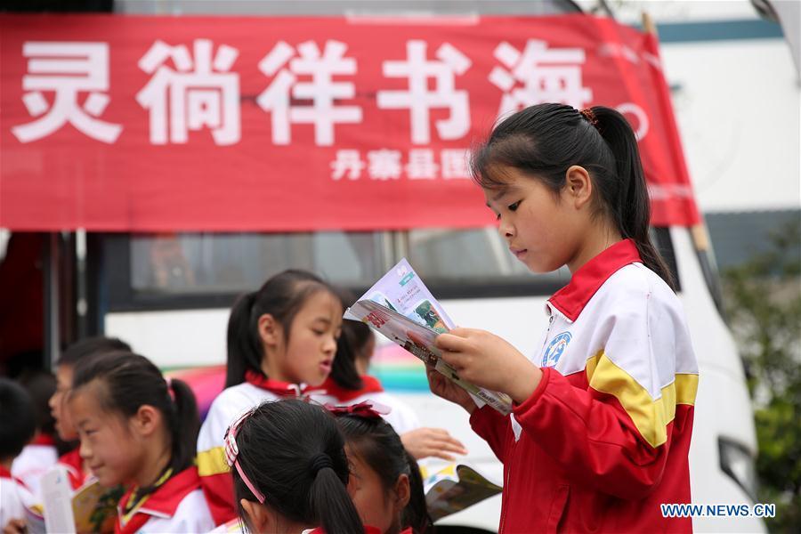 Students read books in front of a \