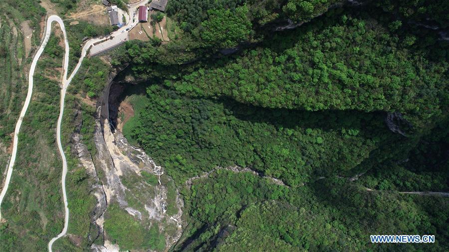 Aerial photo taken on April 22, 2019 shows the Didonghe Tiankeng, a giant karst sinkhole at Huoshizi Village of Ningqiang County in Hanzhong, northwest China\'s Shaanxi Province. With a maximum depth of 340 meters, the Didonghe Tiankeng is the largest in Chanjiayan Tiankeng Group in Ningqiang County. (Xinhua/Zhang Bowen)