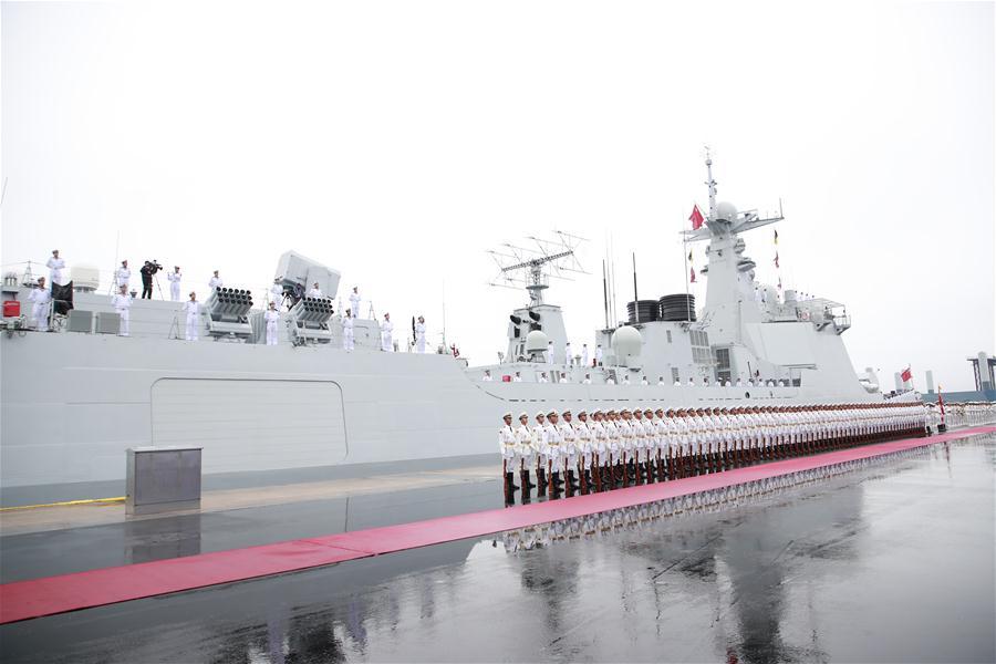 The honor guard of the Chinese People\'s Liberation Army (PLA) Navy stand in formation before a naval parade staged to mark the 70th founding anniversary of the PLA Navy at a pier in Qingdao, east China\'s Shandong Province, on April 23, 2019. (Xinhua/Li Gang)