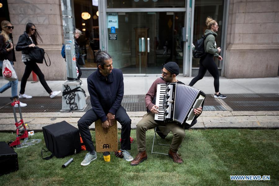 Musicians perform on a grass-covered patch of Broadway during the Car Free Earth Day 2019 in New York, the United States, April 27, 2019. The annual event was created to help raise awareness about environmentally friendly ways to get around town. (Xinhua/Michael Nagle)