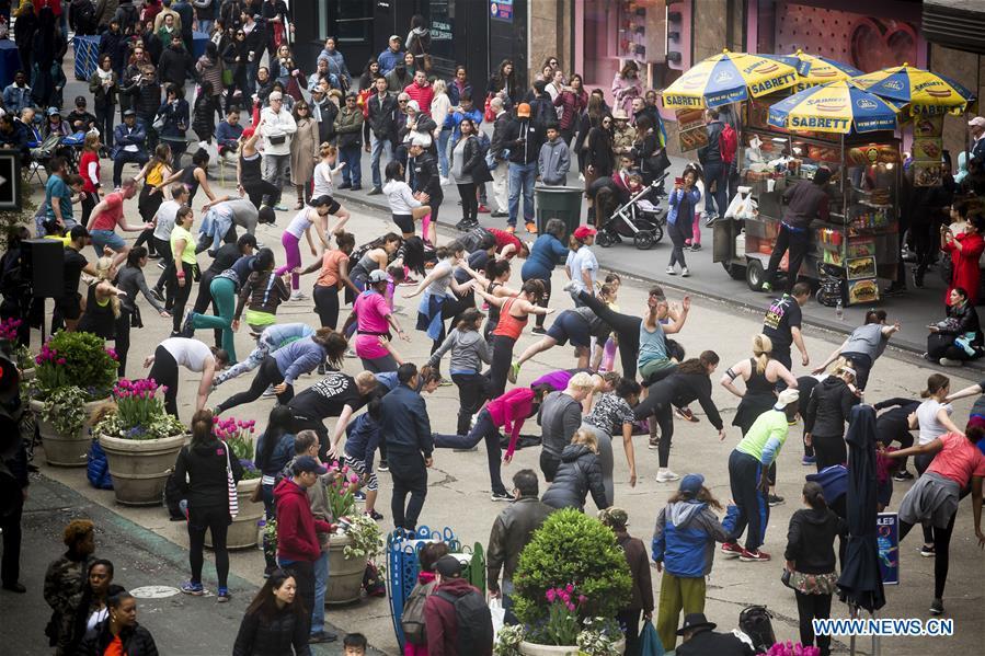 People participate in an exercise class in Herald Square during the Car Free Earth Day 2019 in New York, the United States, April 27, 2019. The annual event was created to help raise awareness about environmentally friendly ways to get around town. (Xinhua/Michael Nagle)