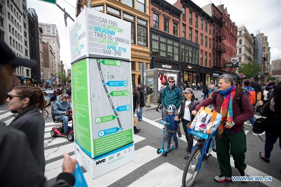 Pedestrians pass a map of the street closures on Broadway during the Car Free Earth Day 2019 in New York, the United States, April 27, 2019. The annual event was created to help raise awareness about environmentally friendly ways to get around town. (Xinhua/Michael Nagle)