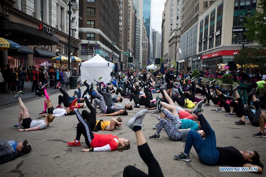 People participate in an exercise class in Herald Square during the Car Free Earth Day 2019 in New York, the United States, April 27, 2019. The annual event was created to help raise awareness about environmentally friendly ways to get around town. (Xinhua/Michael Nagle)