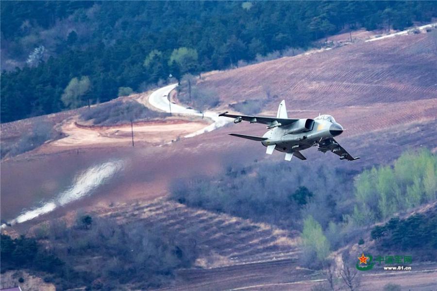 A PLA Air Force warplane in an ultra-low altitude flight training in a valley, April 25, 2019. (Photo/81.cn)