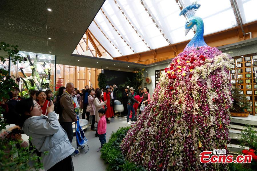 People visit the China Pavilion during the 2019 Beijing International Horticultural Exhibition in Yanqing District of Beijing, China, April 29, 2019. At the center of the expo site stands the Chinese Pavilion, a curved exhibition hall in the shape of a \