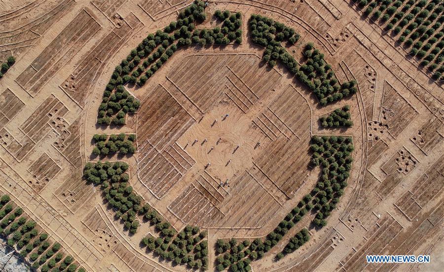 Aerial photo taken on May 2, 2019 shows workers planting trees at the site of ecological restoration project on Jinling iron mine in Caiyuan Township of Qian\'an City, north China\'s Hebei Province. Local government has devoted to the reclamation and afforestation of mine areas in recent years. (Xinhua/Yang Shiyao)