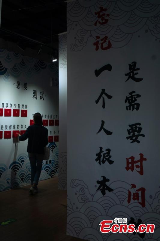 A woman visits the Museum of Broken Relationships in Beijing, May 4, 2019. Hundreds of souvenirs from break-ups, such as unwanted gifts, are presented in the museum. (Photo: China News Service/Zhang Xinglong)