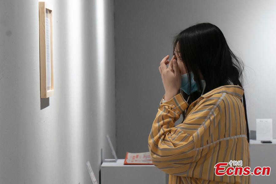 A woman visits the Museum of Broken Relationships in Beijing, May 4, 2019. Hundreds of souvenirs from break-ups, such as unwanted gifts, are presented in the museum. (Photo: China News Service/Zhang Xinglong)