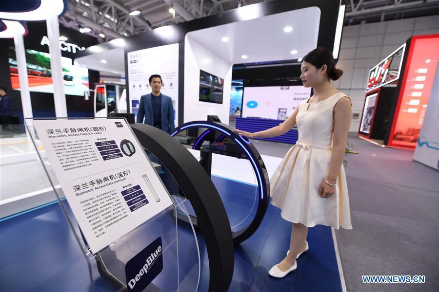 A staff member shows a biometric access gate made by DeepBlue Technology (Shanghai) Co., Ltd. at the 2nd Digital China Exhibition in Fuzhou, southeast China\'s Fujian Province, May 5, 2019. The 2nd Digital China Exhibition runs from May 5 to 9 at the Fuzhou Strait International Conference & Exhibition Center. (Xinhua/Lin Shanchuan)
