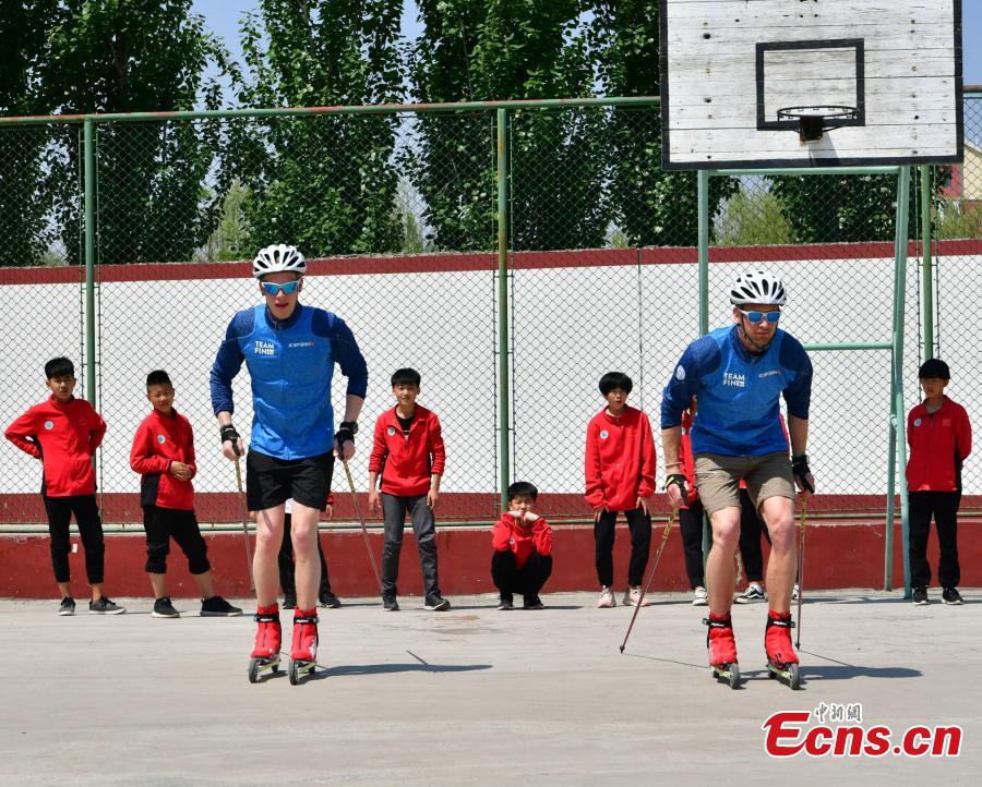 Coaches from Finland instruct students at the Youth Winter Olympic Sports School, or Xuanhua No. 2 Middle School, in Zhangjiakou, Hebei Province, May 9, 2019. The school established in 2015 is the only of its kind to specialize on training of Winter Olympic sports in China. The school has recruited more than 1,200 students, including 200 trained to be competitive skiers. Located some 200km northwest of Beijing, Zhangjiakou will host snowboarding, freestyle skiing, cross-country skiing, ski jumping, Nordic combined and biathlon competitions during the 2022 Winter Games. (Photo: China News Service/Zhai Yujia)